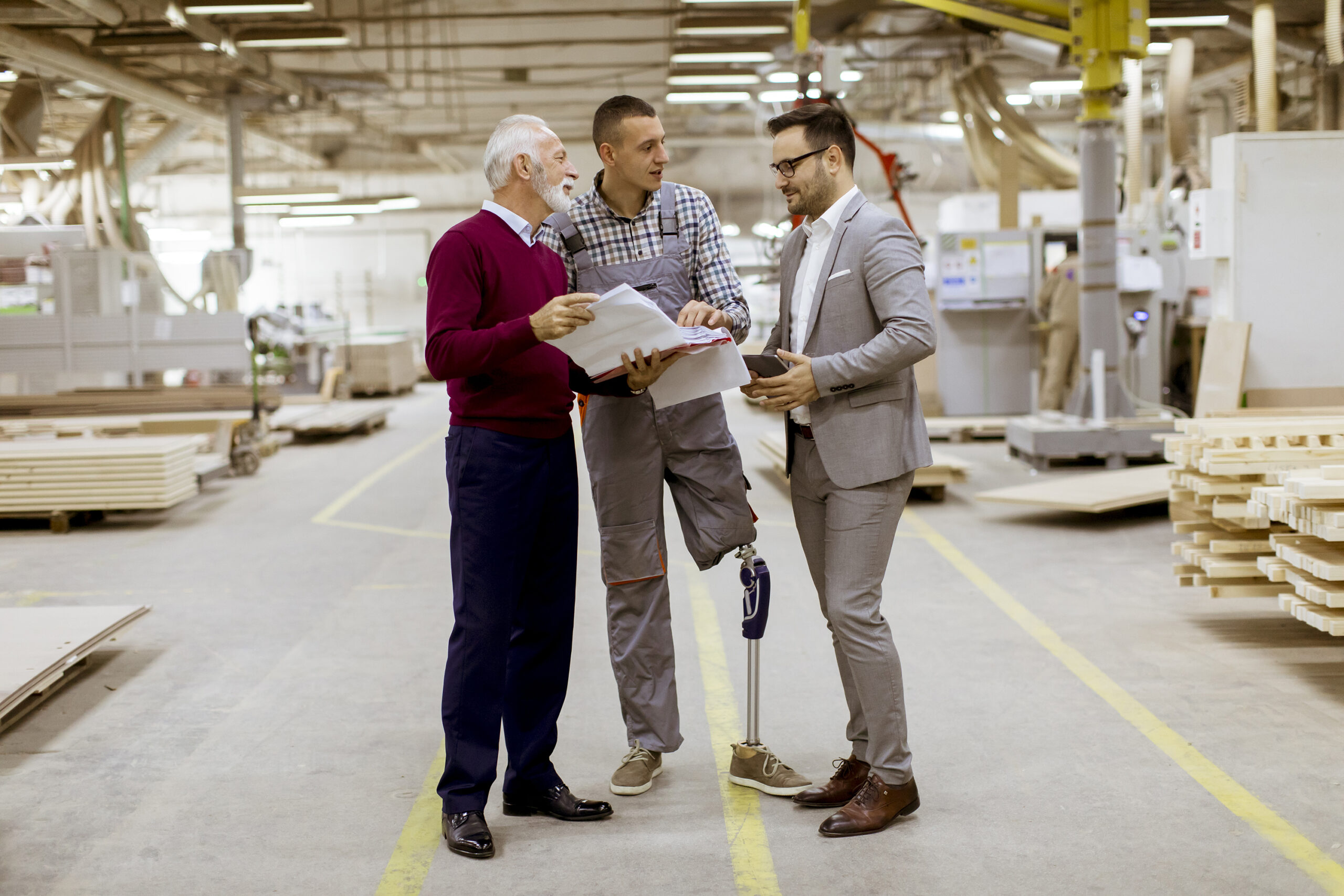 Pracodawcy 1 three men standing and discuss in furniture factor 2026 03 19 05 38 25 utc scaled